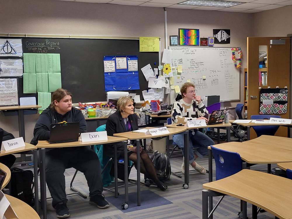 students and the mayor sitting listening to a discussion