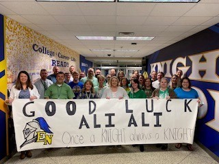 group of teachers holding a sign that says "Good Luck Ali Ali, "once a knight always a knight"