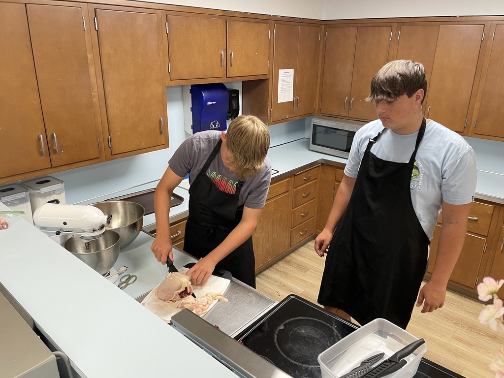 students cooking in a classroom cooking lab